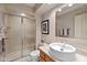 Bathroom with a modern vanity, vessel sink, framed mirror, and glass-enclosed shower stall at 4711 Bentley Dr, Carmel, IN 46033