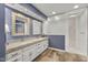 Beautiful blue bathroom with a granite double vanity, tile floors, and a glass enclosed shower at 4711 Bentley Dr, Carmel, IN 46033