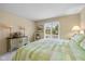 Bright bedroom with a queen size bed, dresser, and large window with neighborhood views at 4711 Bentley Dr, Carmel, IN 46033