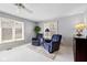 Bright bedroom featuring neutral walls, plush carpet, two comfortable chairs, and plenty of natural light at 4711 Bentley Dr, Carmel, IN 46033
