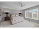 Bedroom featuring neutral decor, large window, ceiling fan, and cozy ambiance at 4711 Bentley Dr, Carmel, IN 46033