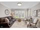 Cozy den featuring a comfortable sofa, natural light, and decorative elements at 4711 Bentley Dr, Carmel, IN 46033
