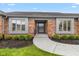 Inviting entryway featuring a curved walkway, brick facade, and well-maintained landscaping at 4711 Bentley Dr, Carmel, IN 46033