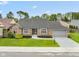 Charming brick home with manicured lawn and gray trim, showcasing classic curb appeal at 4711 Bentley Dr, Carmel, IN 46033