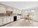 The kitchen features white cabinets, stainless steel appliances, a breakfast nook, and a large window at 4711 Bentley Dr, Carmel, IN 46033