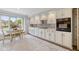 Bright kitchen features white cabinets, stainless steel appliances, and a breakfast nook with neighborhood views at 4711 Bentley Dr, Carmel, IN 46033