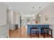 Bright kitchen features hardwood floors, granite countertops, a large island, and pendant lighting at 4711 Bentley Dr, Carmel, IN 46033