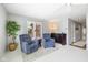 Cozy living room with plush armchairs, a green plant, and natural light from the window at 4711 Bentley Dr, Carmel, IN 46033