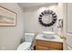 Elegant powder room featuring a vessel sink, granite countertop, and a decorative mirror at 4711 Bentley Dr, Carmel, IN 46033