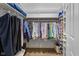 Well-organized walk-in closet with ample hanging space, shelving, and hardwood floors providing storage solutions at 4711 Bentley Dr, Carmel, IN 46033