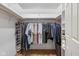 Spacious walk-in closet with wood floors, rods, shelves and shoe racks for organized storage solutions at 4711 Bentley Dr, Carmel, IN 46033