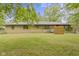 Enjoy the outdoors in this spacious backyard with mature trees, stone exterior and furniture at 5005 Bonnie Brae St, Indianapolis, IN 46228
