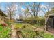 Serene backyard featuring garden beds, winding stone pathways, and a glimpse of the tool shed at 5005 Bonnie Brae St, Indianapolis, IN 46228