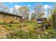 This backyard showcases a serene pond with a waterfall, complemented by lush landscaping and a charming shed at 5005 Bonnie Brae St, Indianapolis, IN 46228