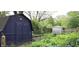 Large backyard with mature greenery, a shed, and a gazebo at 5005 Bonnie Brae St, Indianapolis, IN 46228