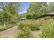 Backyard features landscaping, walking path, and stone exterior home at 5005 Bonnie Brae St, Indianapolis, IN 46228