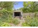 Landscaped backyard featuring a gazebo, lush greenery, and a charming garden pathway at 5005 Bonnie Brae St, Indianapolis, IN 46228