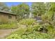 Tranquil backyard pond with a small waterfall, surrounded by vibrant plants and foliage at 5005 Bonnie Brae St, Indianapolis, IN 46228