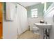 Cozy bathroom featuring a shower, pedestal sink, and neutral color palette at 5005 Bonnie Brae St, Indianapolis, IN 46228