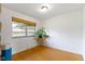 Bright bedroom with hardwood floors and a large window overlooking the lush greenery at 5005 Bonnie Brae St, Indianapolis, IN 46228