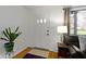 Cozy entryway with hardwood floors, a side table and view to a charming front porch at 5005 Bonnie Brae St, Indianapolis, IN 46228