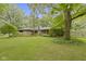 Charming single-story home with a well-maintained lawn and mature trees at 5005 Bonnie Brae St, Indianapolis, IN 46228