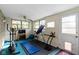 Spacious home gym with workout equipment, natural light, and neutral tones at 5005 Bonnie Brae St, Indianapolis, IN 46228
