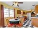 Cozy kitchen and dining area featuring a vintage black and white tiled floor and wooden cabinets at 5005 Bonnie Brae St, Indianapolis, IN 46228