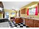 Bright eat-in kitchen with stainless steel appliances, charming black and white checkered floor at 5005 Bonnie Brae St, Indianapolis, IN 46228