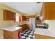 Kitchen with checkered floor, stainless steel appliances and wooden cabinets at 5005 Bonnie Brae St, Indianapolis, IN 46228