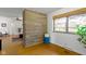 Living room with a stone accent wall, hardwood floors, and natural light at 5005 Bonnie Brae St, Indianapolis, IN 46228