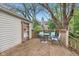Wooden back deck with table, seating and an adjacent outdoor storage area at 5254 Kingsley Dr, Indianapolis, IN 46220