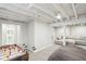 Finished basement featuring a sofa, a foosball table, and exposed beams at 5254 Kingsley Dr, Indianapolis, IN 46220