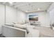 Finished basement featuring a large television, gray carpet, and exposed beams at 5254 Kingsley Dr, Indianapolis, IN 46220