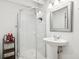 Modern bathroom featuring a glass shower, pedestal sink, and stylish fixtures at 5254 Kingsley Dr, Indianapolis, IN 46220