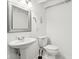 Cozy bathroom featuring a sleek pedestal sink, toilet, and modern fixtures at 5254 Kingsley Dr, Indianapolis, IN 46220