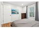 Modern bedroom with hardwood floors, a wall-mounted TV, and neutral tones at 5254 Kingsley Dr, Indianapolis, IN 46220