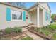 Charming single-story home featuring a manicured lawn, light siding, and bright blue shutters at 5254 Kingsley Dr, Indianapolis, IN 46220