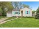 Charming single-story home featuring a manicured lawn, light siding, and bright blue shutters at 5254 Kingsley Dr, Indianapolis, IN 46220