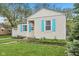 Charming single-story home featuring a manicured lawn, light siding, and bright blue shutters at 5254 Kingsley Dr, Indianapolis, IN 46220
