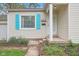 Charming single-story home featuring a manicured lawn, light siding, and bright blue shutters at 5254 Kingsley Dr, Indianapolis, IN 46220