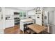 Bright kitchen featuring white cabinets, subway tile backsplash, stainless steel appliances, and a kitchen island at 5254 Kingsley Dr, Indianapolis, IN 46220