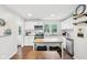 Bright kitchen with white cabinetry, stainless steel appliances, an island and a view out the windows at 5254 Kingsley Dr, Indianapolis, IN 46220