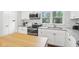 Contemporary kitchen with white cabinets, subway tile and modern appliances for a sleek cooking space at 5254 Kingsley Dr, Indianapolis, IN 46220