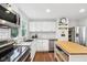 Modern kitchen features white cabinets, subway tile, stainless steel appliances, and a view of the backyard at 5254 Kingsley Dr, Indianapolis, IN 46220
