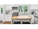 Bright kitchen features subway tile backsplash, stainless appliances, and a functional island with seating at 5254 Kingsley Dr, Indianapolis, IN 46220