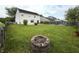 Large fenced backyard featuring a fire pit, garden beds, and plenty of green space at 5849 Wooden Branch Dr, Indianapolis, IN 46221