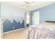 Bedroom with blue walls, a queen bed and a mountain mural accent wall at 5849 Wooden Branch Dr, Indianapolis, IN 46221