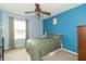 Bedroom with green bedspread, window and view of connected living space at 5849 Wooden Branch Dr, Indianapolis, IN 46221