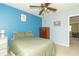 Bedroom with blue walls, a ceiling fan and a light wood dresser at 5849 Wooden Branch Dr, Indianapolis, IN 46221